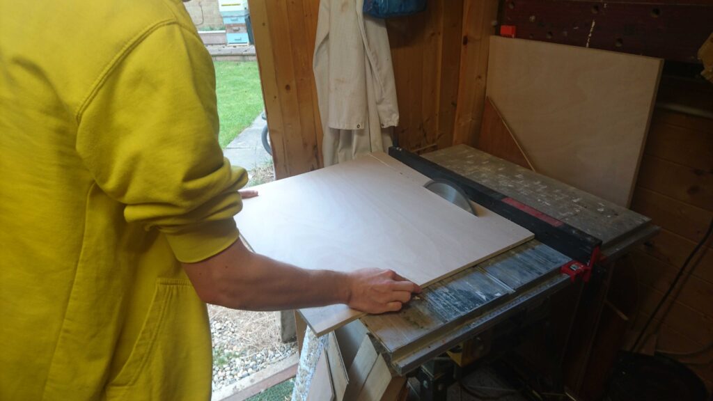 Cutting the first peice of the arcade cabinet on a bandsaw