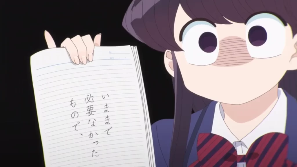 A picture of the main character komi (right) holding up a note written in japanese. 