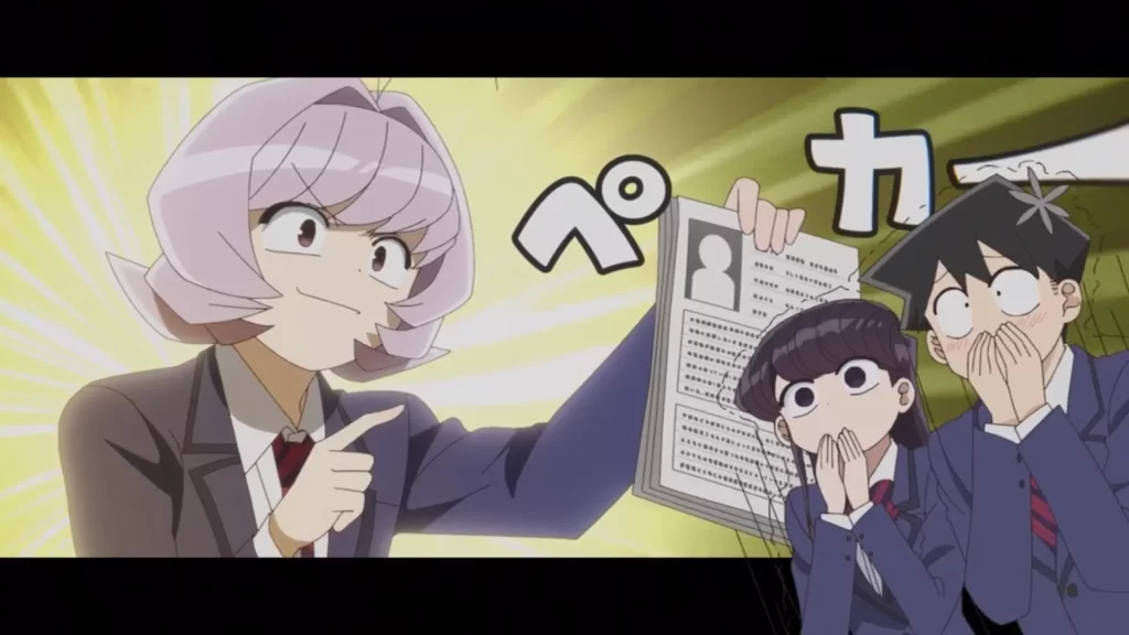A screenshot with Komi & Tadano (right) in shock at what is being shown to them on the paper being help by another classmate (left).